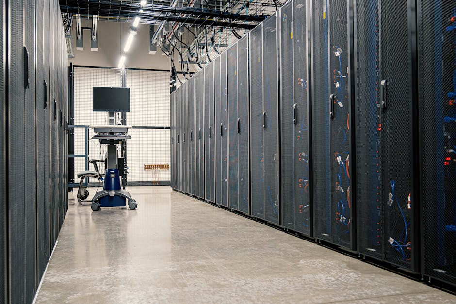 A lone technician in a dimly lit server room, flashlight in hand, reading rack labels, focused and unbothered, cinematic wide-angle shot