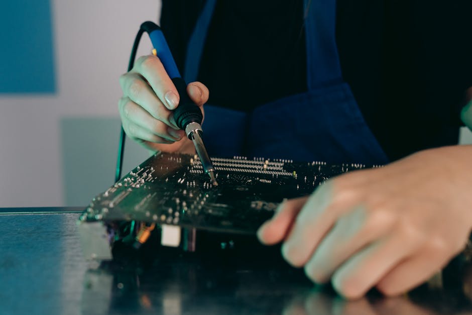 Close-up of circuit board repair work under magnification, soldering iron in hand, warm workshop lighting, shallow depth of field