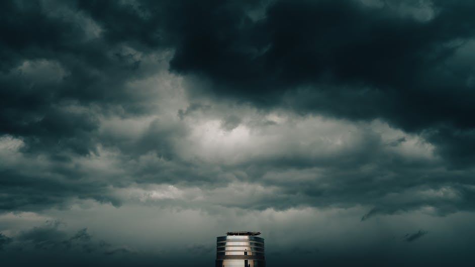 Federal Reserve building exterior with dramatic storm clouds overhead, moody cinematic lighting