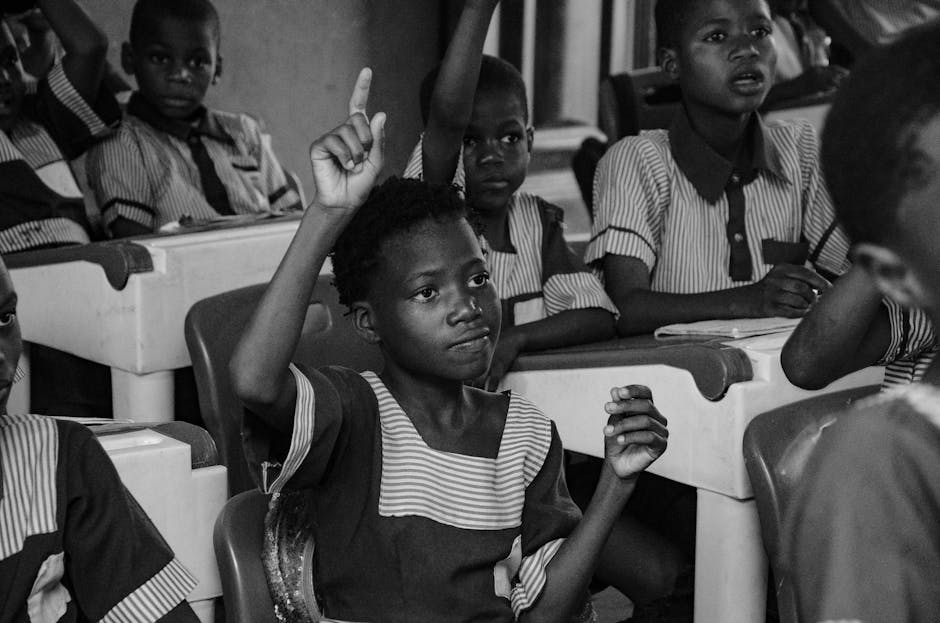 An old factory-era classroom with rows of identical desks, children sitting rigidly, black and white photography style, moody lighting