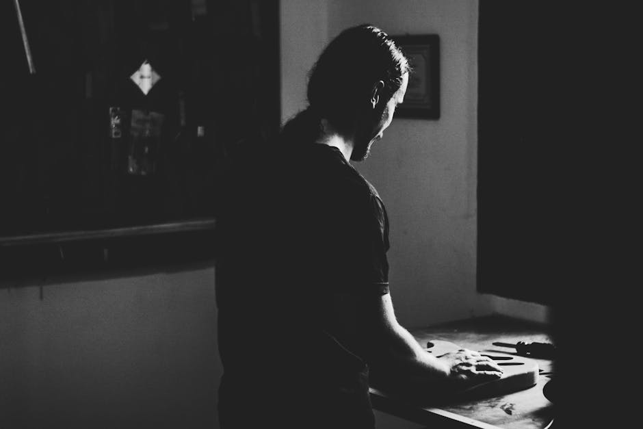 A person working alone at a glowing monitor in a dark room, terminal output scrolling, focused and calm — moody blue light, cinematic atmosphere