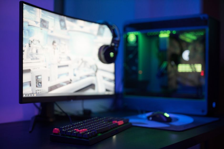 A gaming setup with a Linux terminal and Steam running, dramatic RGB lighting, wide angle shot
