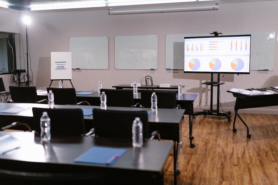 A sleek marketing presentation screen glowing in a dark conference room, empty chairs, single spotlight, wide angle, moody cinematic lighting