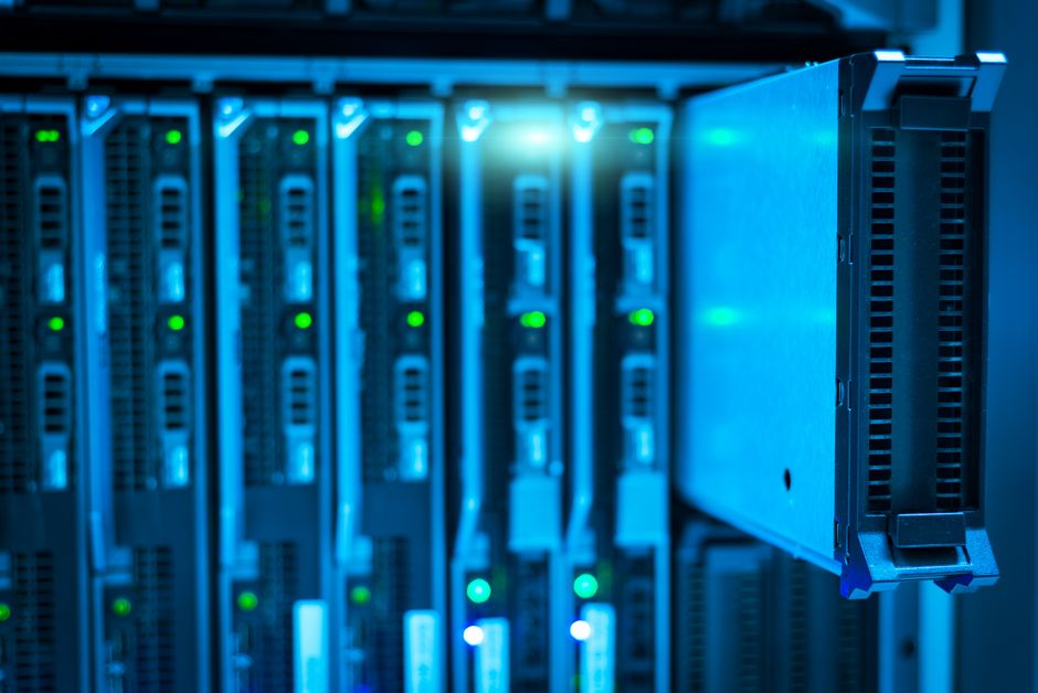 Rows of physical servers in a data center being replaced by glowing cloud infrastructure icons, split image showing old and new, wide angle, cool blue lighting, photorealistic